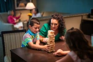 family playing Jenga in family suite room