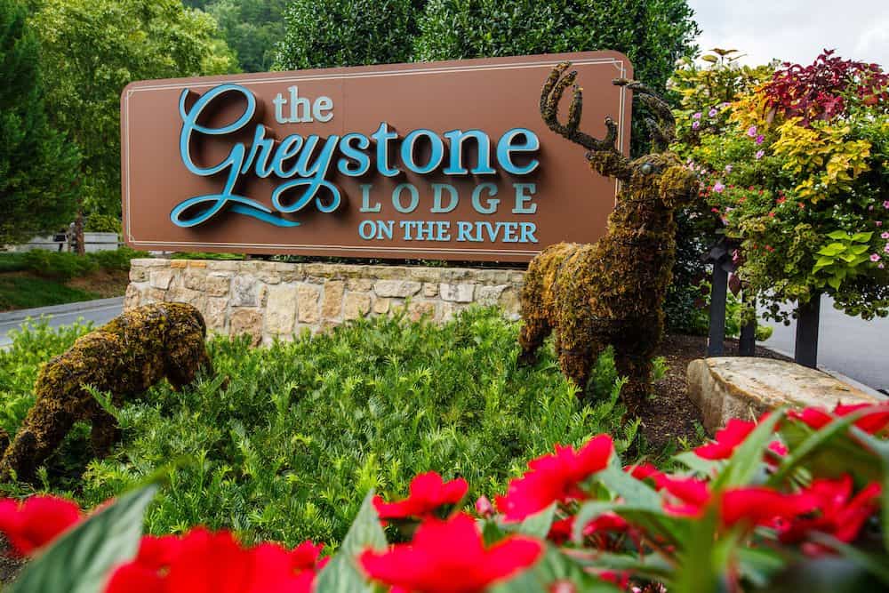sign outside of the Greystone Lodge on the River