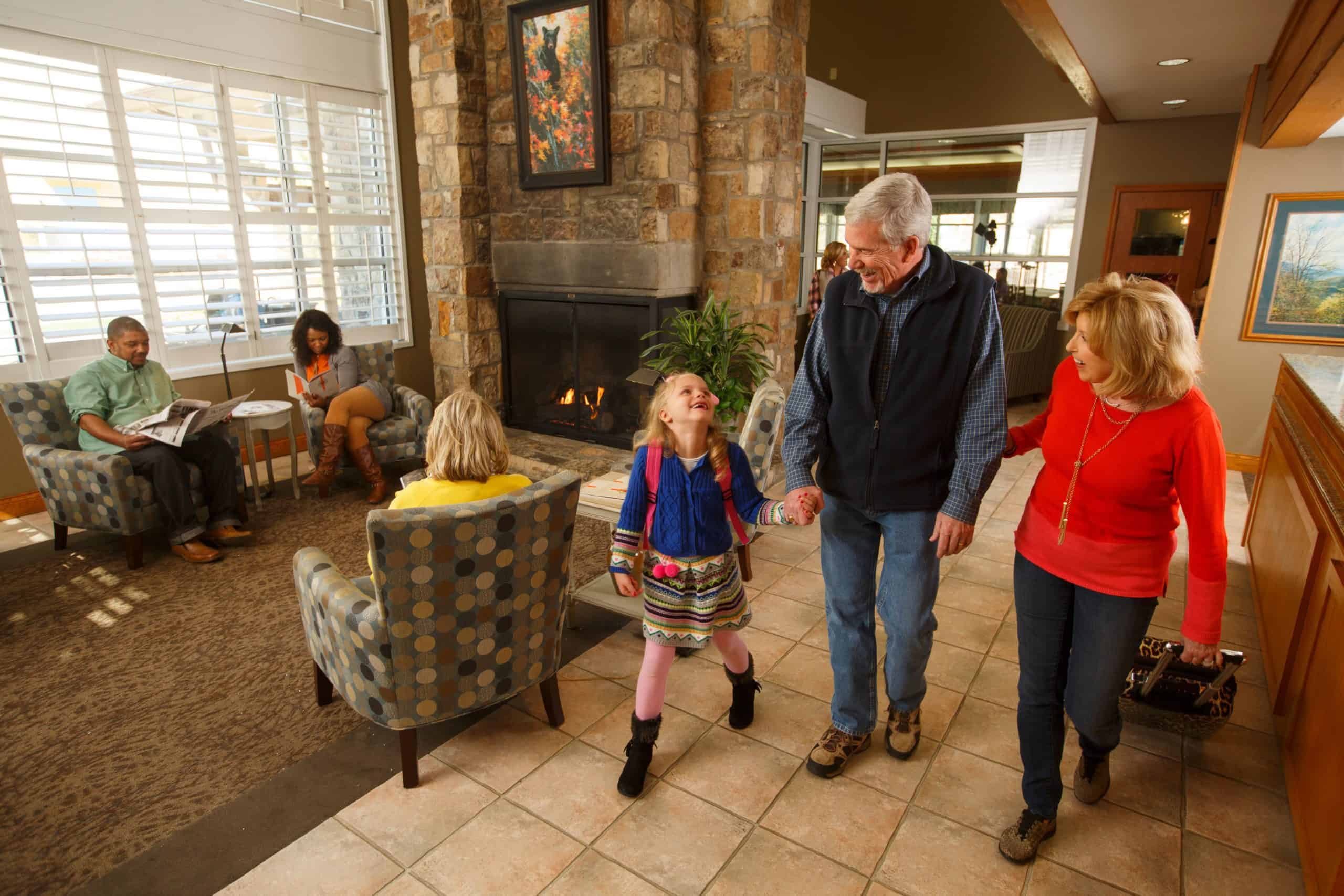 family walking through the lobby of The Greystone Lodge